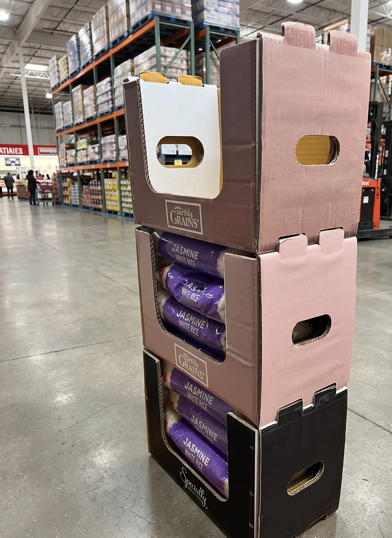 Three stacked PDQ display boxes on a store floor