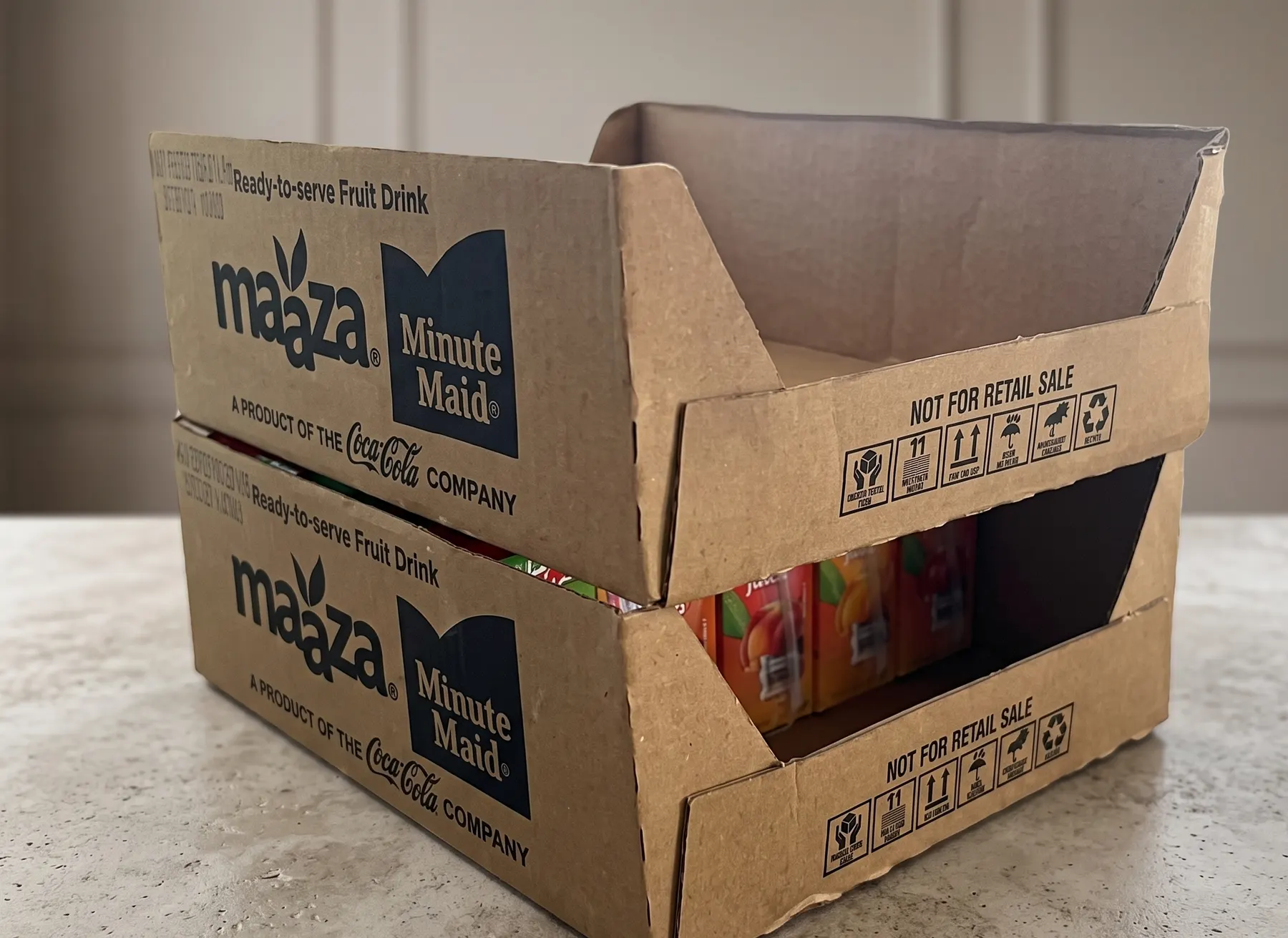 Stacked printed kraft trays for fruit drink cartons
